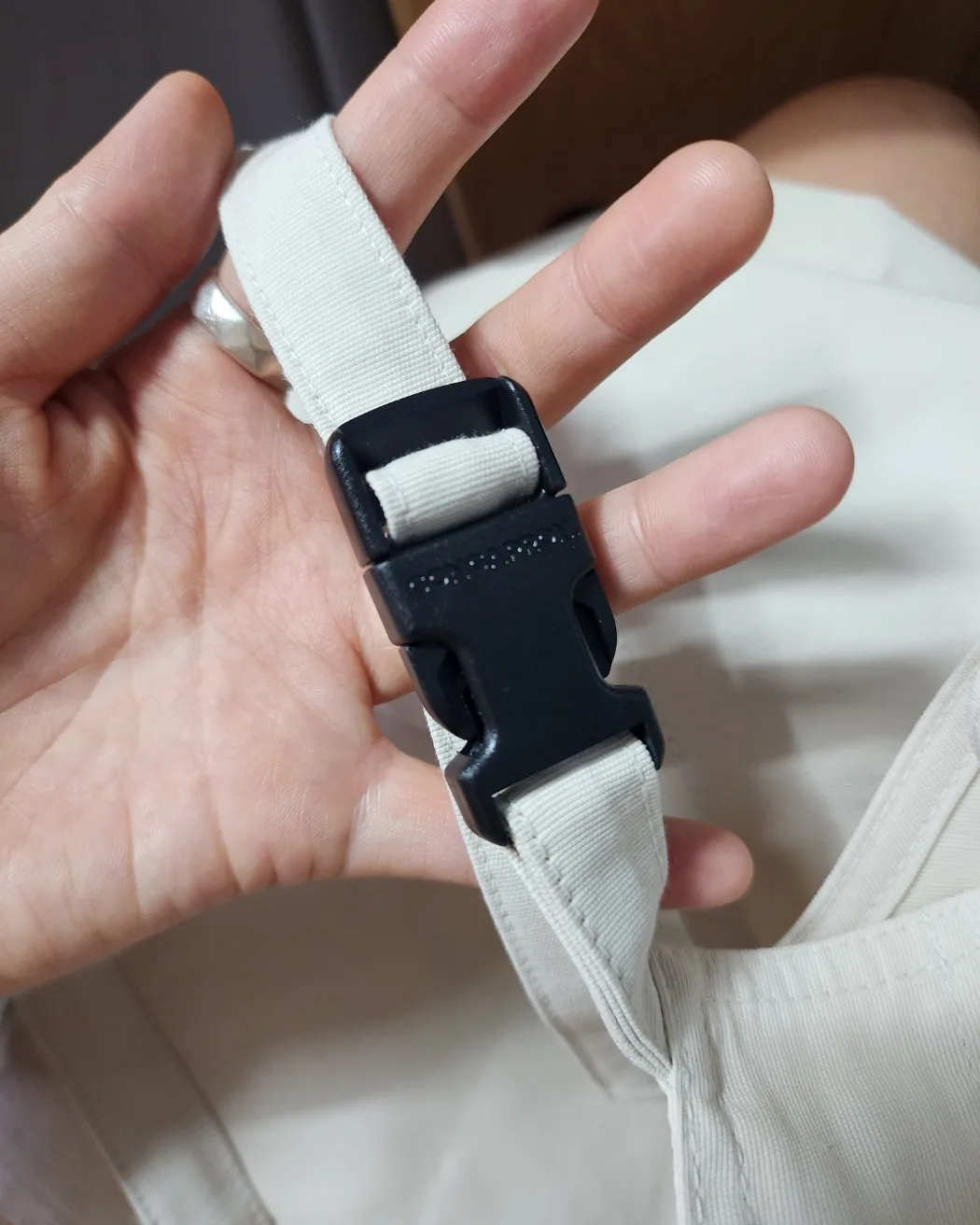 An adjustable buckle on an apron shoulder strap
