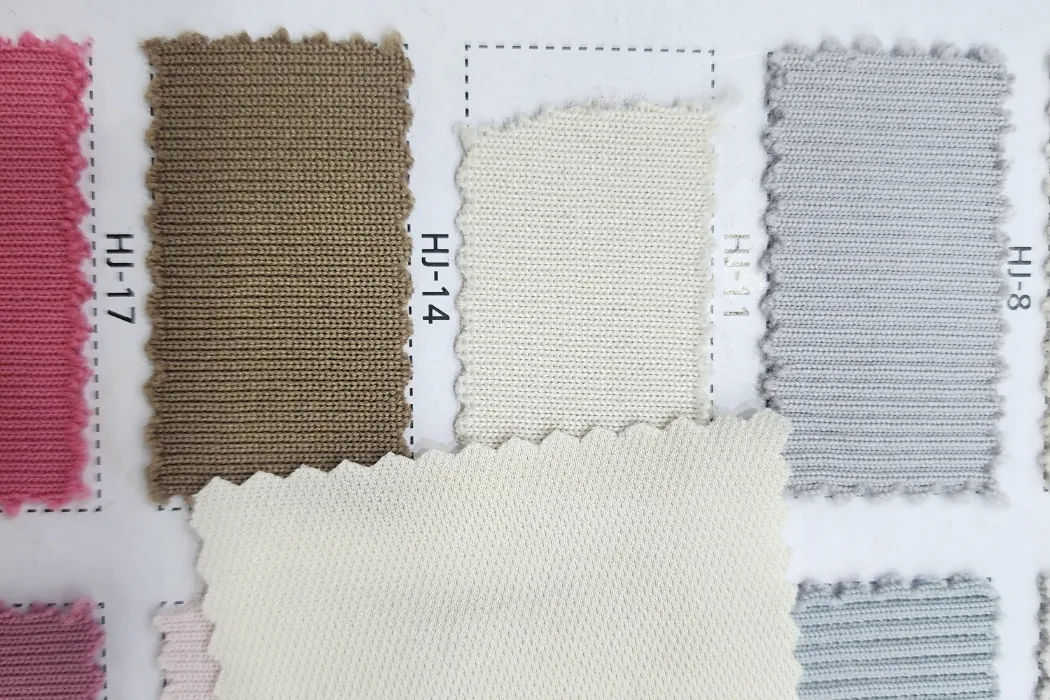 A fabric swatch card with knit samples in several colors and textures