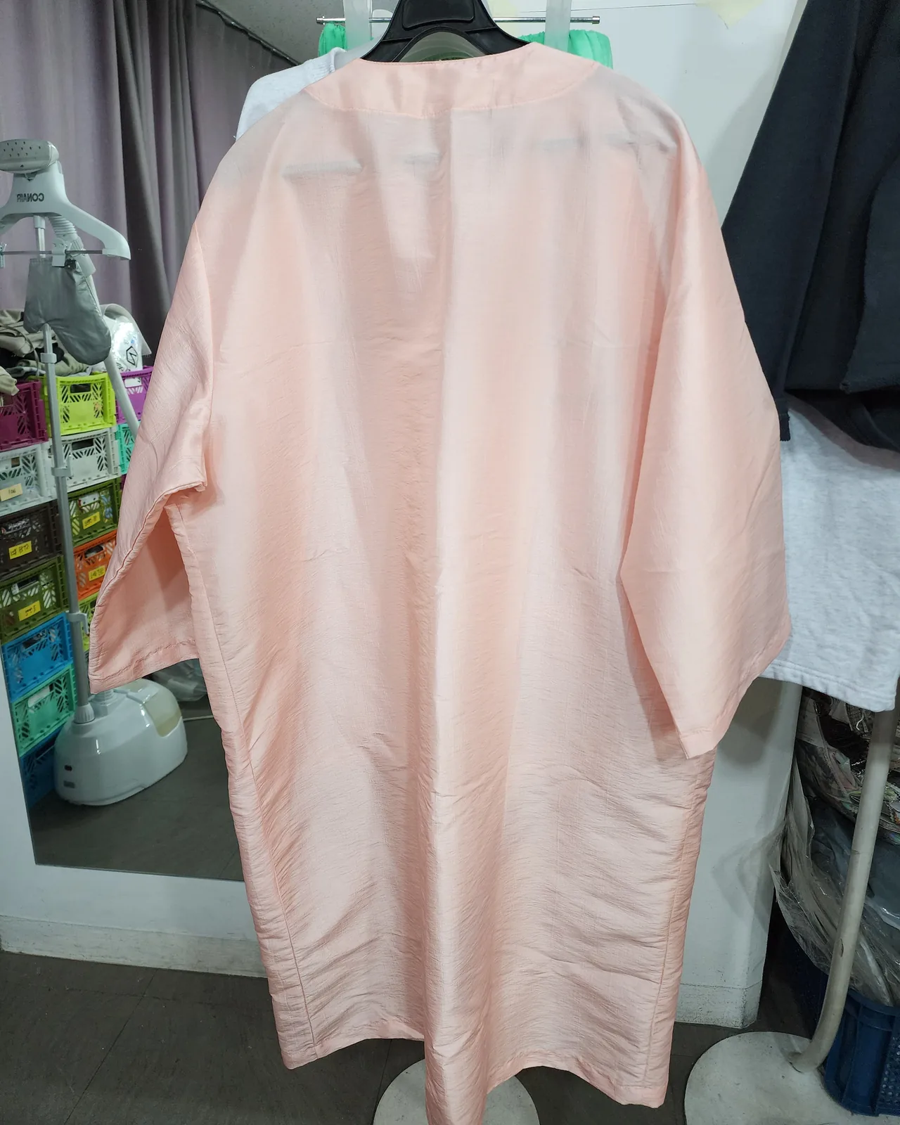 The back of a pale pink guest gown made for a salon