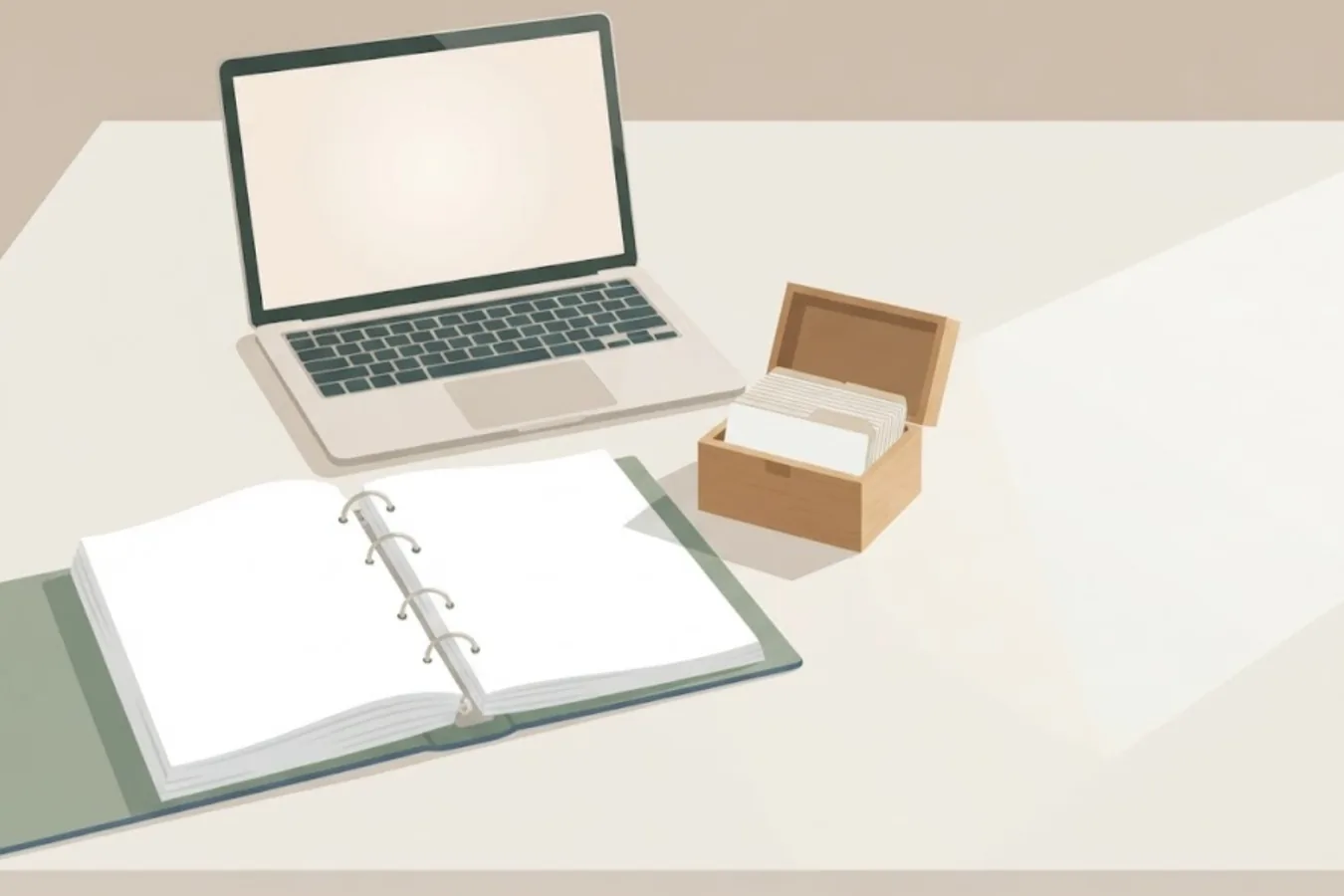 An open binder with every page gone blank, beside a box of index cards stored one by one — an illustration made for this post