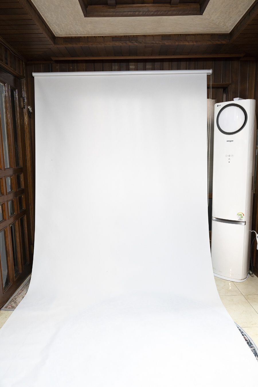A white paper backdrop rolled out at Botong Lee Studio